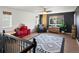 Bright room with black accent wall, stylish rug, wood floors, and black leather chair offers modern comfort at 2853 Black Canyon Way, Castle Rock, CO 80109