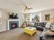 Cozy living room featuring a fireplace, large leather sofa, and an abundance of natural light at 2853 Black Canyon Way, Castle Rock, CO 80109