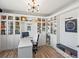 Bright office featuring custom built-in shelving, laminate wood flooring, and a modern chandelier at 2853 Black Canyon Way, Castle Rock, CO 80109