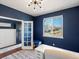 Stylish office space with wood-look floors, dark navy accent wall, and a modern light fixture at 2853 Black Canyon Way, Castle Rock, CO 80109