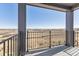 Balcony view showing off the iron railing and an expansive view at 6910 Merseyside Ln, Castle Pines, CO 80108