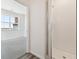 Bathroom showing a large shower with glass doors and view into a bright bedroom with a 'SOLD' sign at 6910 Merseyside Ln, Castle Pines, CO 80108