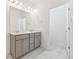 Bathroom features double sink vanity with modern fixtures and tile flooring at 6910 Merseyside Ln, Castle Pines, CO 80108