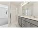 Elegant bathroom with glass-enclosed shower and double sink vanity with quartz countertops at 6910 Merseyside Ln, Castle Pines, CO 80108