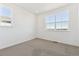 Bright bedroom with large windows offering neighborhood views and neutral carpet flooring at 6910 Merseyside Ln, Castle Pines, CO 80108