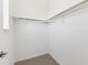 Walk-in closet with ample storage and neutral carpet flooring at 6910 Merseyside Ln, Castle Pines, CO 80108