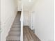Bright entryway featuring stairs to the upper levels and wood-look flooring at 6910 Merseyside Ln, Castle Pines, CO 80108