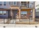 The home's exterior is a mix of brick and siding, a small yard, and a covered porch entry at 6910 Merseyside Ln, Castle Pines, CO 80108