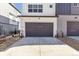 Attached two-car garage with a gray door and a concrete driveway at 6910 Merseyside Ln, Castle Pines, CO 80108