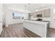 Modern kitchen with an island, stainless steel appliances, and ample cabinet space at 6910 Merseyside Ln, Castle Pines, CO 80108