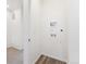 Bright laundry room features wood-look flooring and modern hookups at 6910 Merseyside Ln, Castle Pines, CO 80108