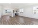Spacious living room featuring hardwood floors, an open layout, and a view to the kitchen at 6910 Merseyside Ln, Castle Pines, CO 80108
