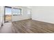 Bright living room with hardwood floors, balcony access, and large window showcasing the view at 6910 Merseyside Ln, Castle Pines, CO 80108