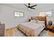 Comfortable bedroom features hardwood floors, a ceiling fan and good natural light from two bright windows at 14185 W 50Th Ave, Golden, CO 80403