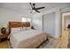 Cozy bedroom features hardwood floors, a ceiling fan and good natural light from a bright window at 14185 W 50Th Ave, Golden, CO 80403