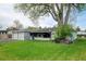 Charming exterior view of house with a large shade tree in a well-manicured front yard at 14185 W 50Th Ave, Golden, CO 80403