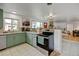 Charming kitchen with stainless steel appliances, light green cabinetry and a window overlooking the backyard at 14185 W 50Th Ave, Golden, CO 80403