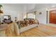 Comfortable living room featuring hardwood floors and a brick fireplace at 14185 W 50Th Ave, Golden, CO 80403