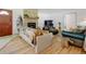 Cozy living room with a brick fireplace and hardwood floors at 14185 W 50Th Ave, Golden, CO 80403
