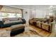 Spacious living room with large windows providing natural light and hardwood floors at 14185 W 50Th Ave, Golden, CO 80403