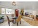 Cozy living room with hardwood floors, brick fireplace and large windows with bright natural light at 14185 W 50Th Ave, Golden, CO 80403