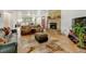 Bright, open living room with a brick fireplace and hardwood flooring at 14185 W 50Th Ave, Golden, CO 80403