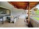 Relaxing covered patio featuring comfortable seating and hanging plants at 14185 W 50Th Ave, Golden, CO 80403