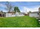 View of backyard sheds with nice lawn, providing additional storage and workshop space in your backyard at 14185 W 50Th Ave, Golden, CO 80403