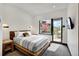 Bright bedroom with a king-size bed and access to a patio at 52 West Point Lode # A, Breckenridge, CO 80424