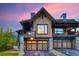 Mountain home exterior at dusk, showcasing stone and wood details at 52 West Point Lode # A, Breckenridge, CO 80424