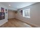 Well-lit basement with a large window and wood-look flooring at 294 Willowick Cir, Highlands Ranch, CO 80129