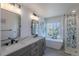 Modern bathroom featuring double sinks, soaking tub, and stylish tiled shower at 294 Willowick Cir, Highlands Ranch, CO 80129