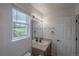A well-lit bathroom with a large mirror and a bright window at 294 Willowick Cir, Highlands Ranch, CO 80129
