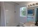Bathroom with a shower-tub combo and a window at 294 Willowick Cir, Highlands Ranch, CO 80129