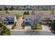 Aerial view of a two-story home with an attached garage, long driveway, and large tree in the front yard at 294 Willowick Cir, Highlands Ranch, CO 80129