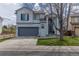 Charming two-story home featuring blue shutters, a well-kept lawn, and an attached two-car garage at 294 Willowick Cir, Highlands Ranch, CO 80129
