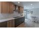 Modern kitchen with stainless steel appliances, a tile backsplash, sleek countertops, and an adjacent dining area at 294 Willowick Cir, Highlands Ranch, CO 80129