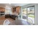 Well-lit kitchen featuring stainless steel appliances, tile backsplash, modern cabinetry, and an adjacent dining area at 294 Willowick Cir, Highlands Ranch, CO 80129
