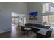 Sunlit living room featuring a large sectional couch, hardwood floors, and an adjacent dining area at 294 Willowick Cir, Highlands Ranch, CO 80129