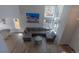 Aerial view of a living room featuring a large couch, dining area, hardwood floors, and ample sunlight at 294 Willowick Cir, Highlands Ranch, CO 80129