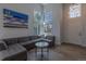 Bright living room with large windows, hardwood floors, comfortable seating, and high ceilings at 294 Willowick Cir, Highlands Ranch, CO 80129