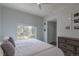 A sun-filled main bedroom features a large window overlooking lush greenery at 294 Willowick Cir, Highlands Ranch, CO 80129