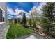 Manicured backyard featuring a pristine lawn, mature trees, and decorative rock beds at 5251 Silver Hare Ct, Castle Rock, CO 80104
