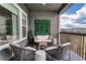 Balcony with chairs, couch, decor and wood railing overlooking backyard at 5251 Silver Hare Ct, Castle Rock, CO 80104