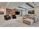 Basement living area featuring a wood accent wall, comfortable seating, and a large flat-screen television at 5251 Silver Hare Ct, Castle Rock, CO 80104
