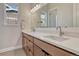 Bathroom with double sink vanity featuring modern chrome faucets, spacious countertop, and decorative mirror at 5251 Silver Hare Ct, Castle Rock, CO 80104