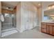 Bathroom featuring tiled floors, glass shower, and wooden vanity with a large mirror at 5251 Silver Hare Ct, Castle Rock, CO 80104