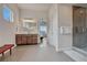 Bright bathroom features tiled floors, glass shower, and wooden vanity with a large mirror at 5251 Silver Hare Ct, Castle Rock, CO 80104