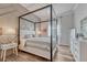 Bedroom featuring wood floors, modern four-poster bed, with accent wall and white nightstand with lighting at 5251 Silver Hare Ct, Castle Rock, CO 80104