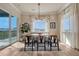 Bright dining room features wood floors, modern light fixture, and sliding door access to a balcony with views at 5251 Silver Hare Ct, Castle Rock, CO 80104